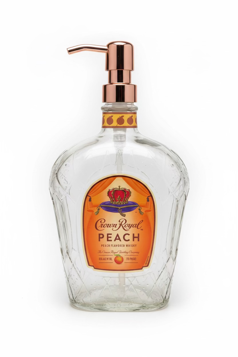 A clear glass soap dispenser with a peach-scented label and a metal pump.