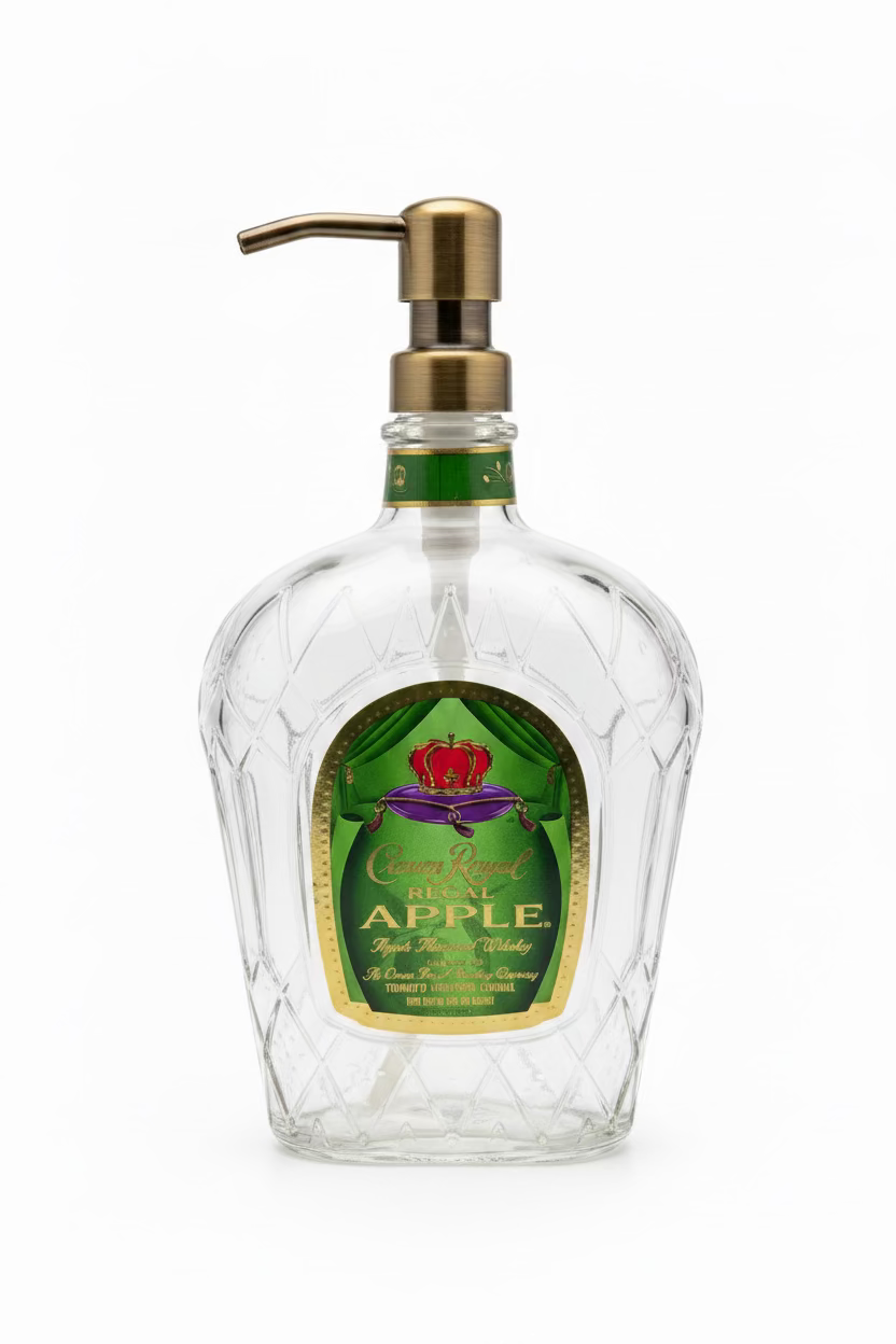 A clear glass soap dispenser with a green label, featuring a metal pump 