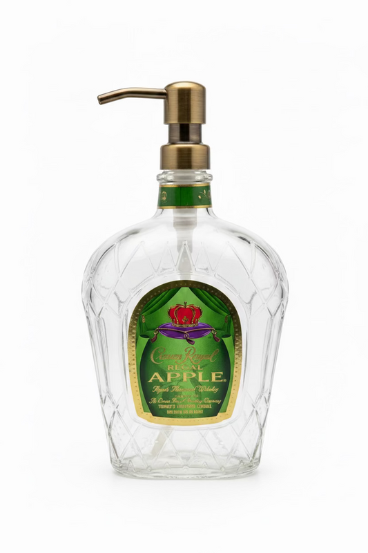A clear glass soap dispenser with a green label, featuring a metal pump 