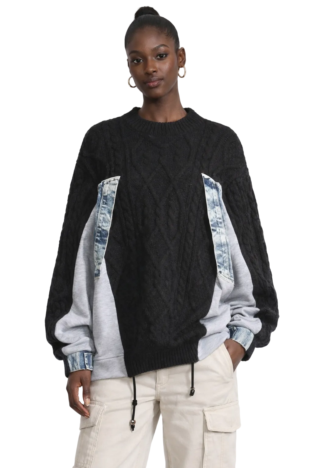 Women wearing a black and gray sweater with denim accents on a white background